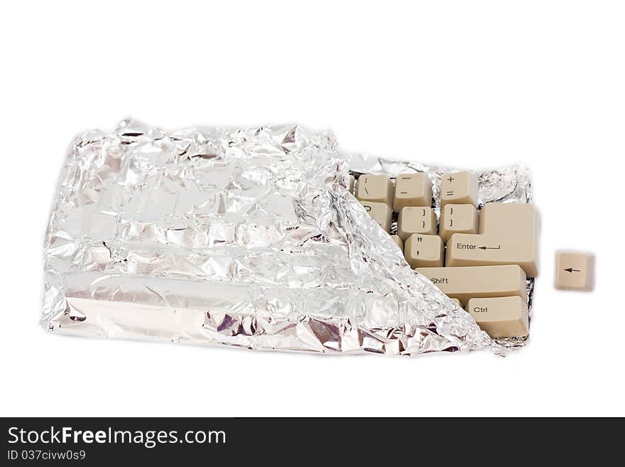 The keyboard in the form of chocolate in foil isolated on a white background. The keyboard in the form of chocolate in foil isolated on a white background