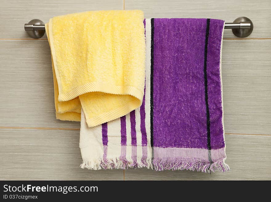 Purple and yellow towels in the bathroom