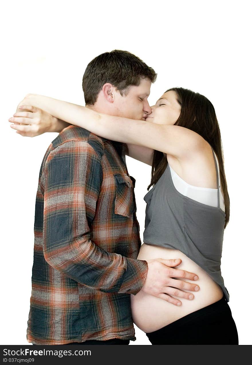 Young Pregnant couple embracing and kissing. Young Pregnant couple embracing and kissing.