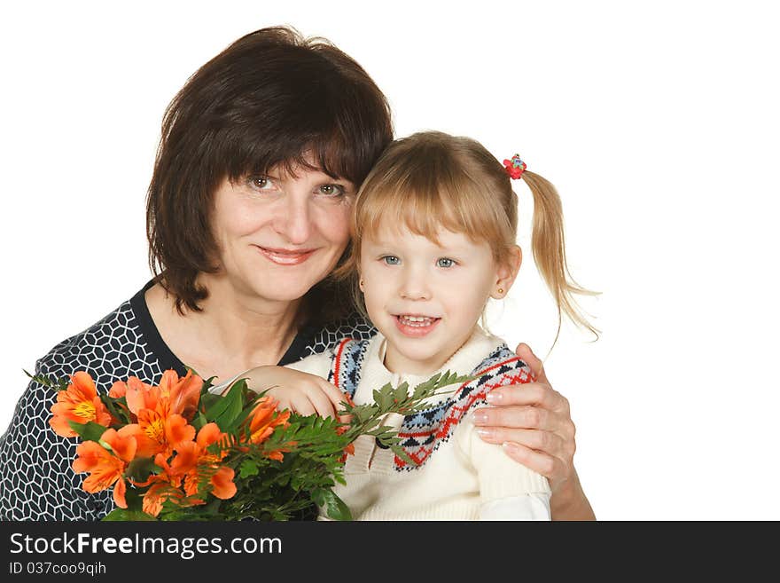 Grandmother and granddaughter with bunch of flower