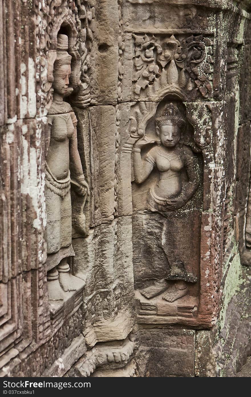 Ancient sculpture on the stone walls of the temple Apsaras at Angkor Wat, Cambodia