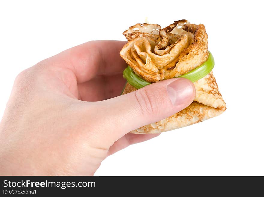 Pancake in hand isolated on white background