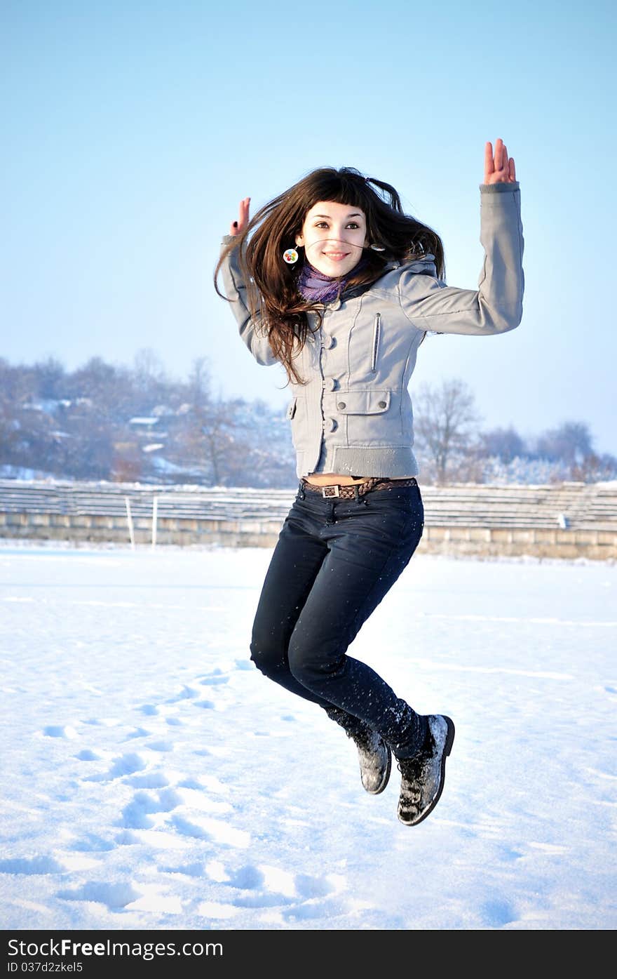 Beautiful Jumping Girl outdoors in winter time