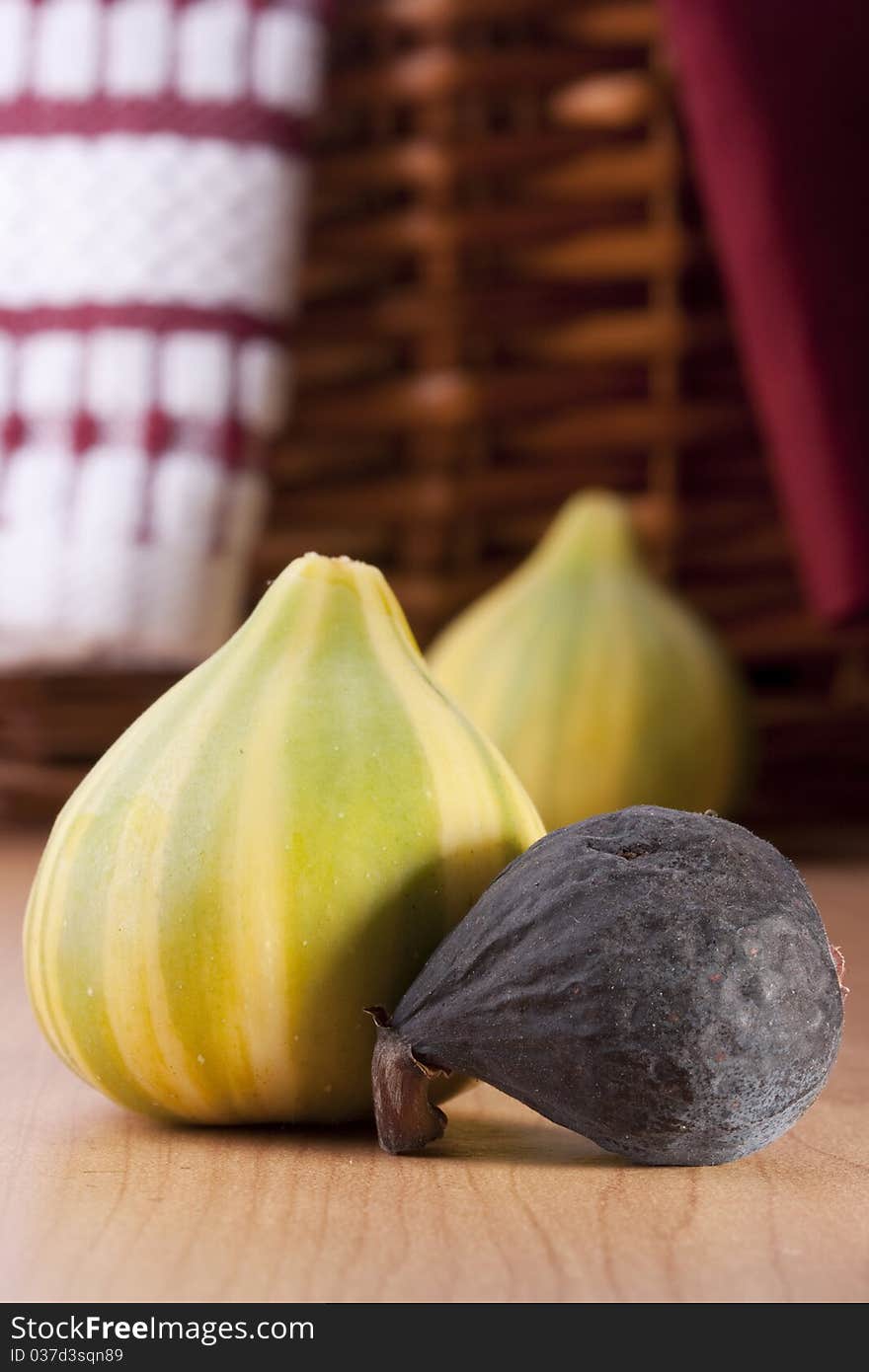 Ripe fruits of a fig on a wooden table.