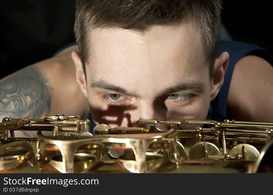 Closeup youngman look on saxophone