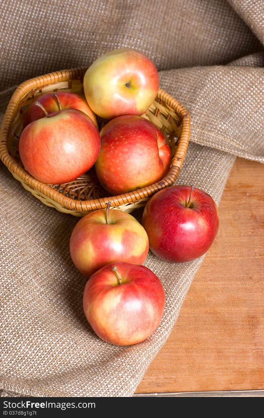 Apples on a sacking on a wooden table still life