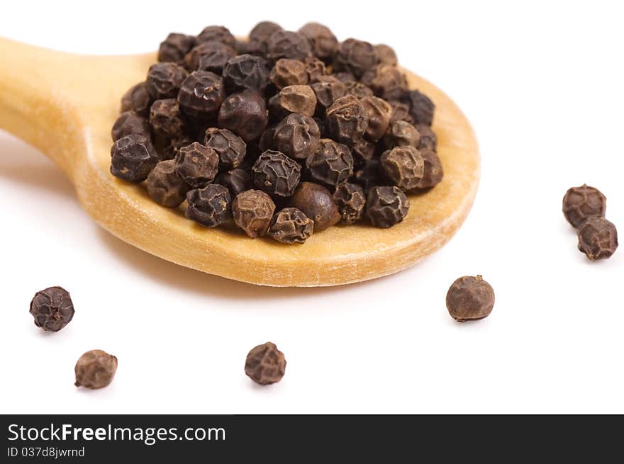 Black Peppercorns on a wooden spoon