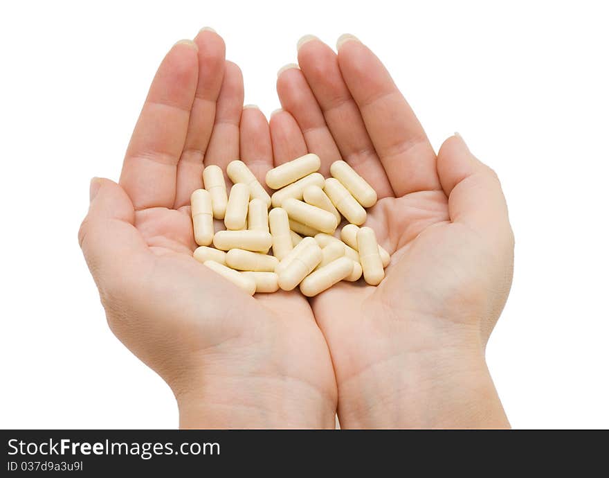 Hand with a pill on white background