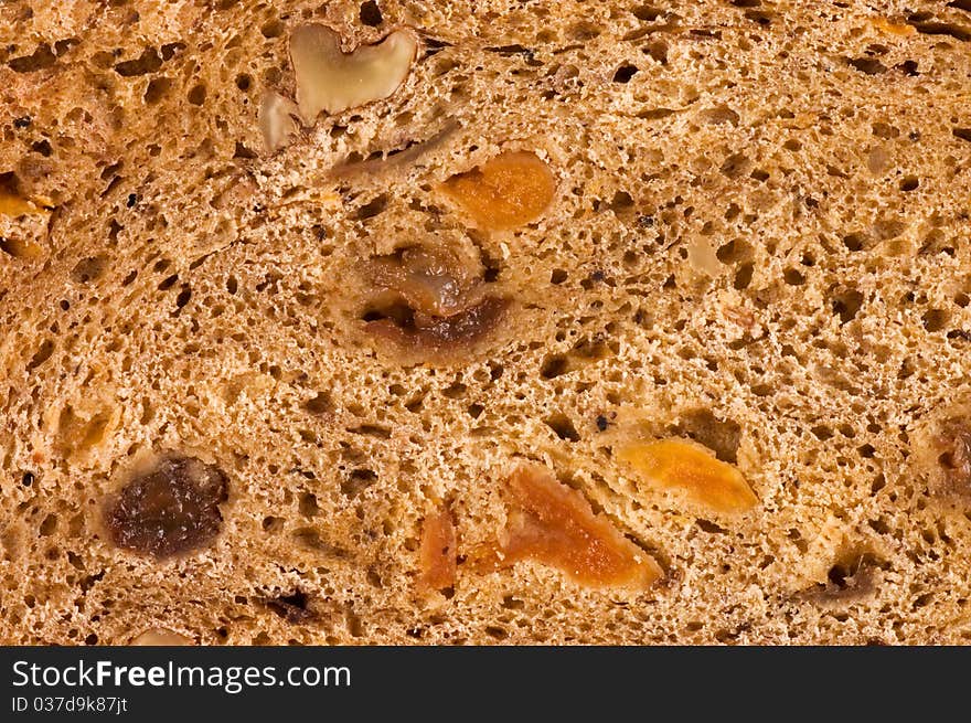 Cut bread with raisin and dried apricots close up