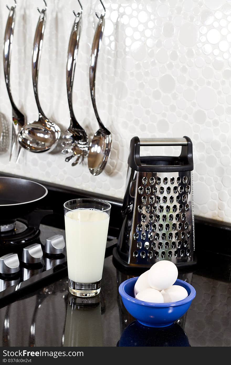 Background of modern kitchen and eggs, milk and grater