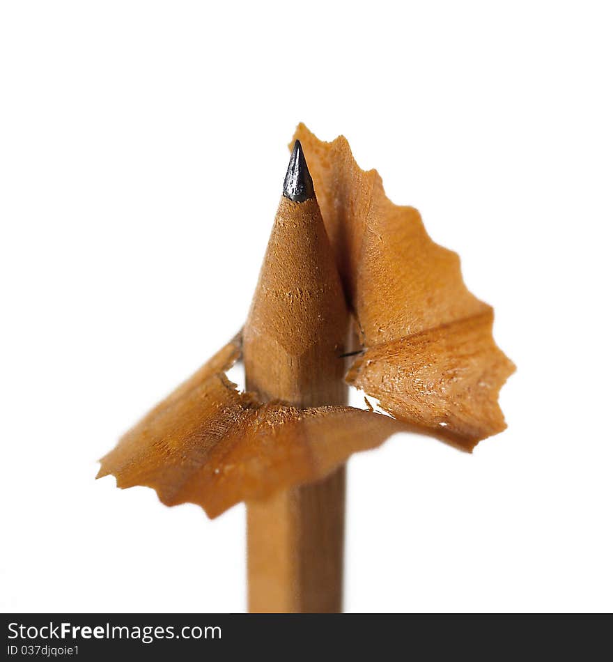 Wooden natural brown sharpened pencil with shavings.