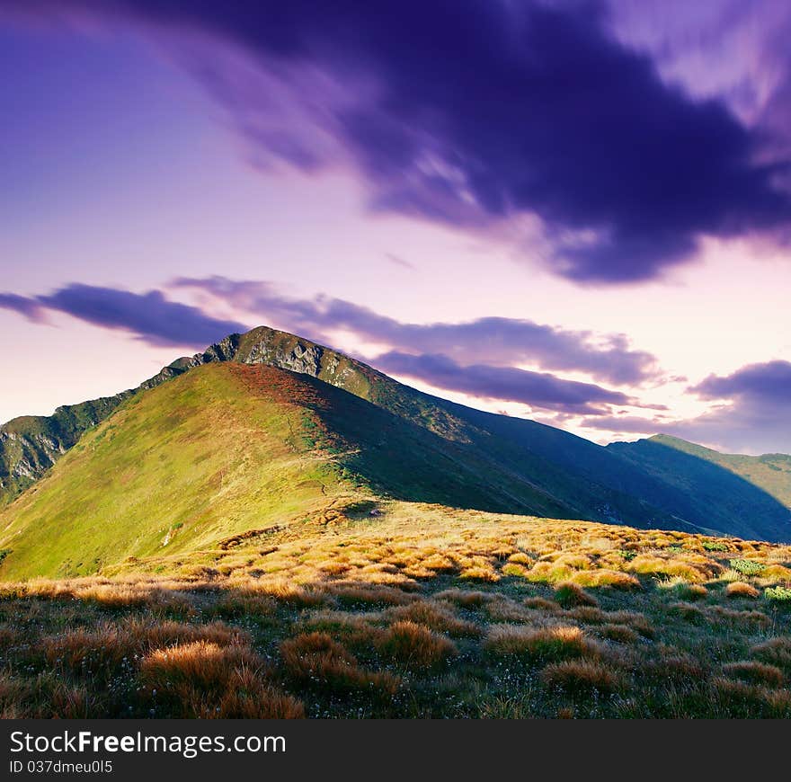 Mountain landscape with the cloudy sky