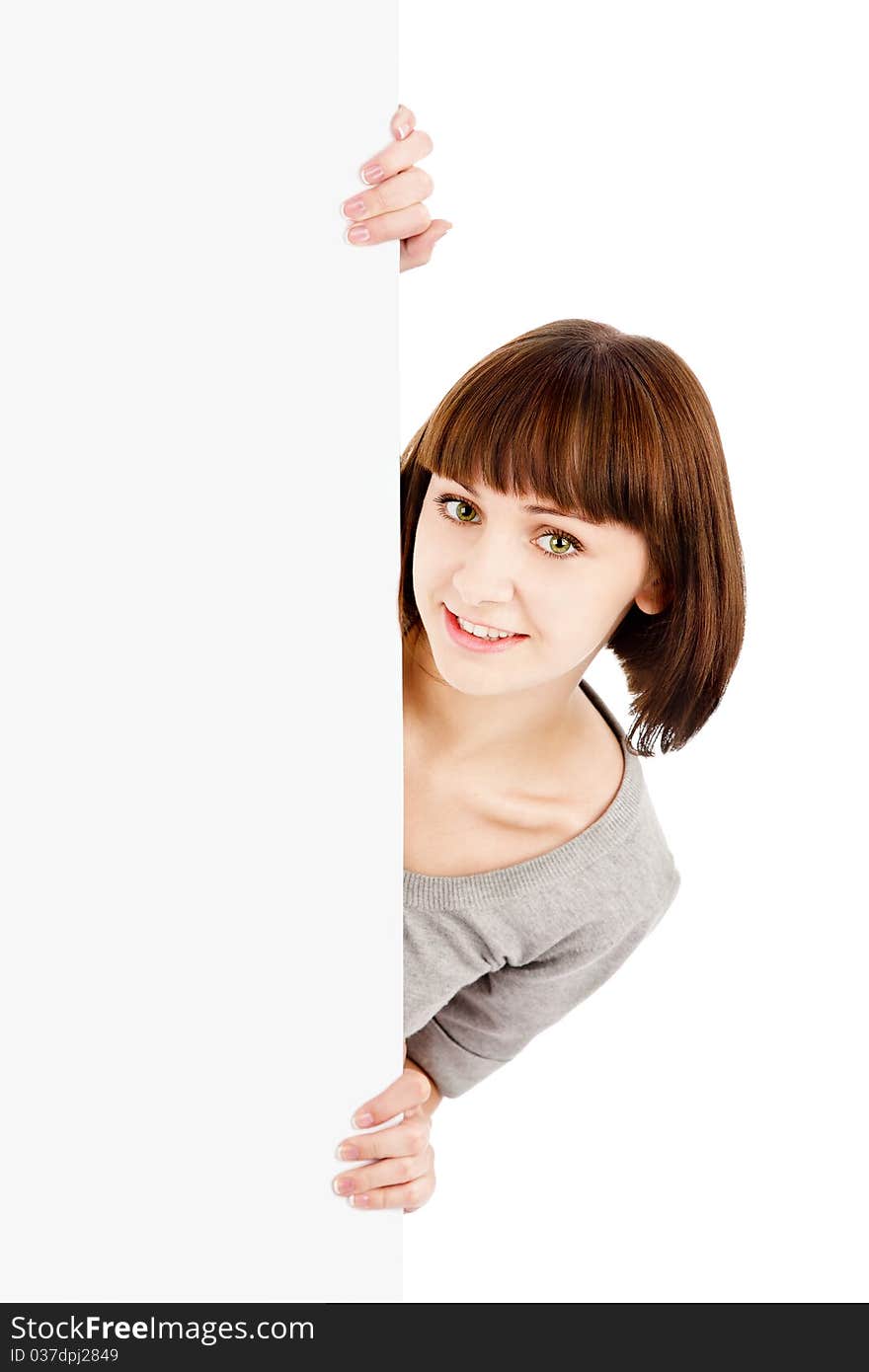 Young smiling woman holding blank billboard sign isolated on white