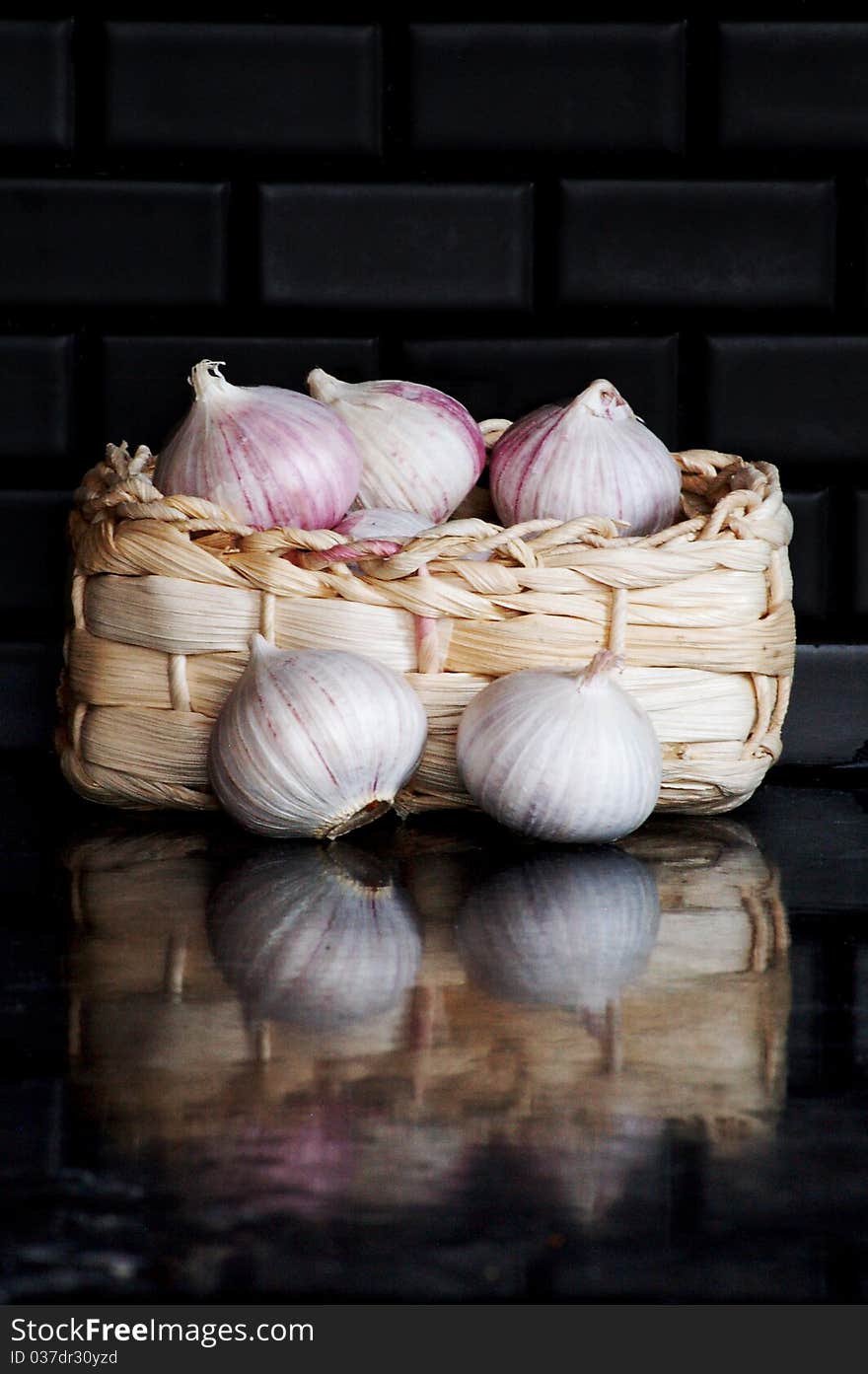 Garlic bulbs in small basket. Garlic bulbs in small basket