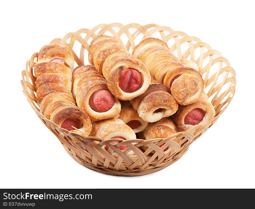 Sausage rolls in pastry in a wicker basket