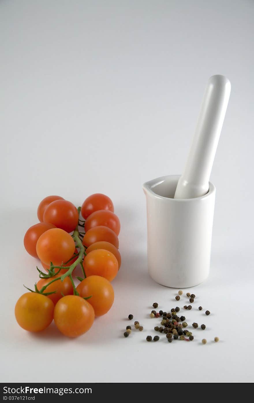 Mortar, pepper and tomatoes on white background. Mortar, pepper and tomatoes on white background.