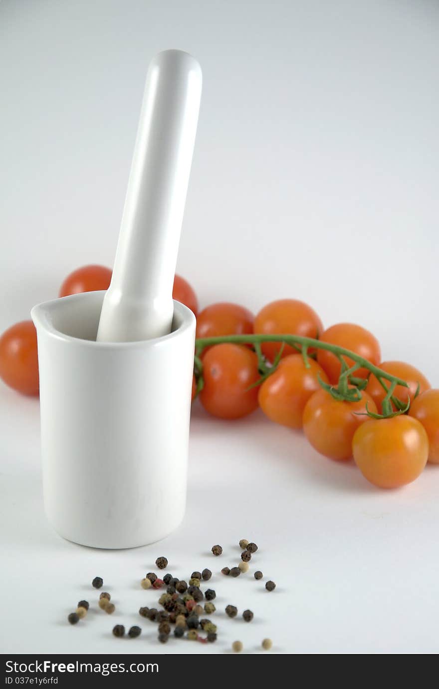 Mortar, pepper and tomatoes on white background. Mortar, pepper and tomatoes on white background.