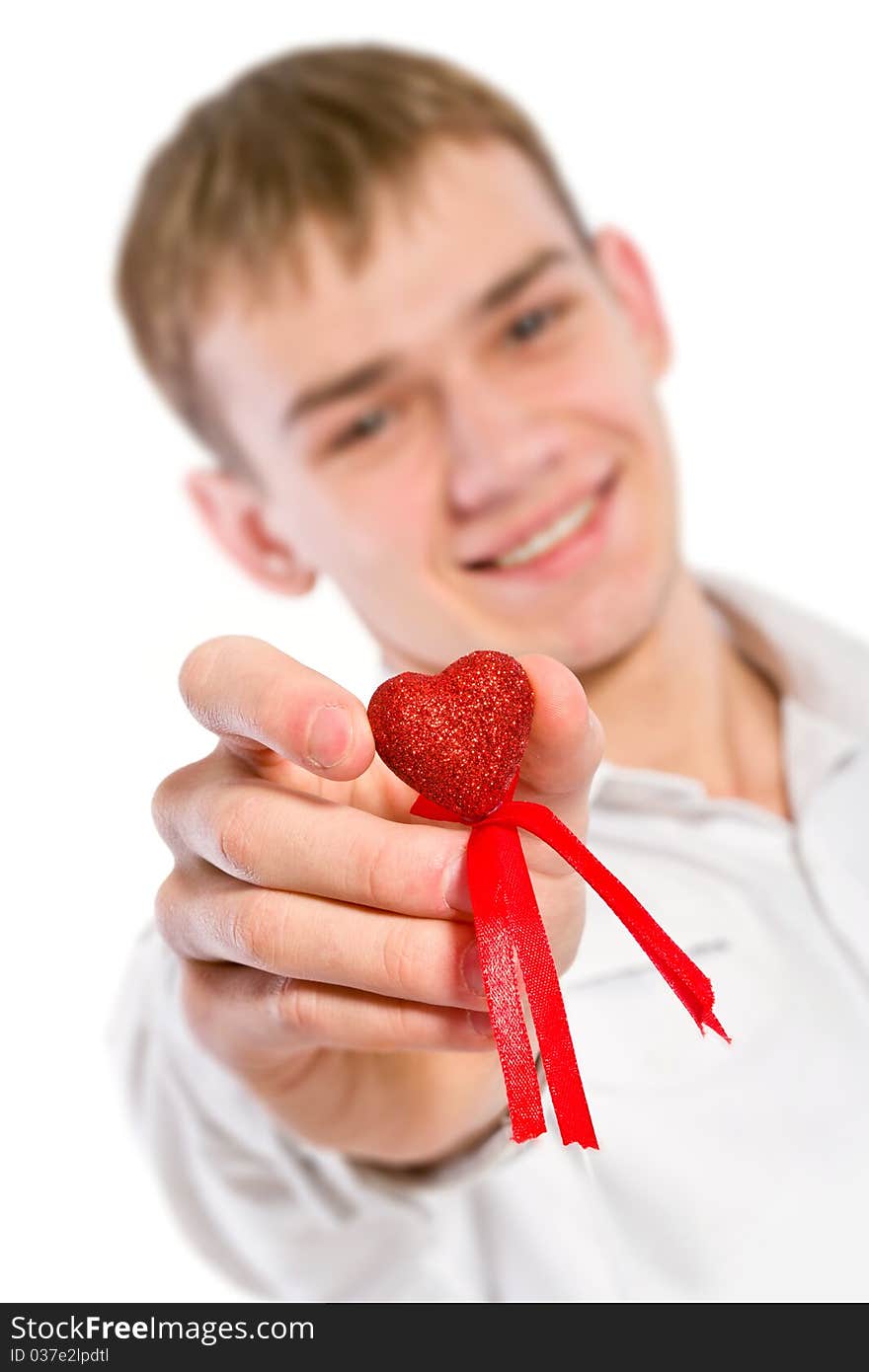 Young man holding heart in his hand. He is giving it somebody. Isolated on white.