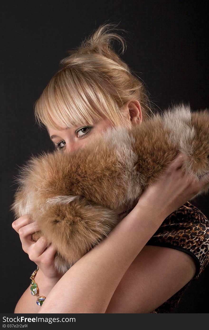 Girl covered her face with fur. Girl covered her face with fur