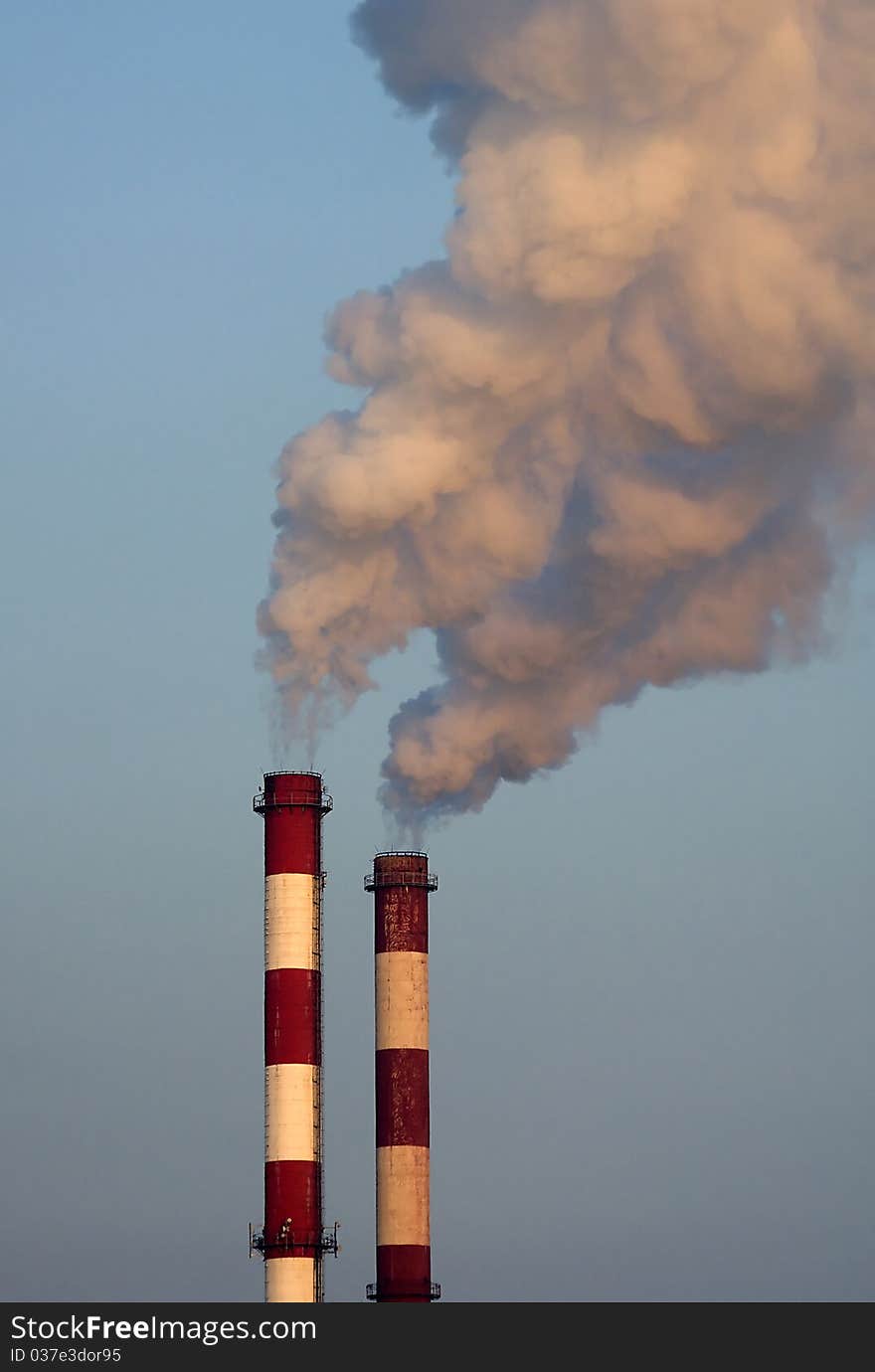 Heating station chimneys with smoke opposite sky