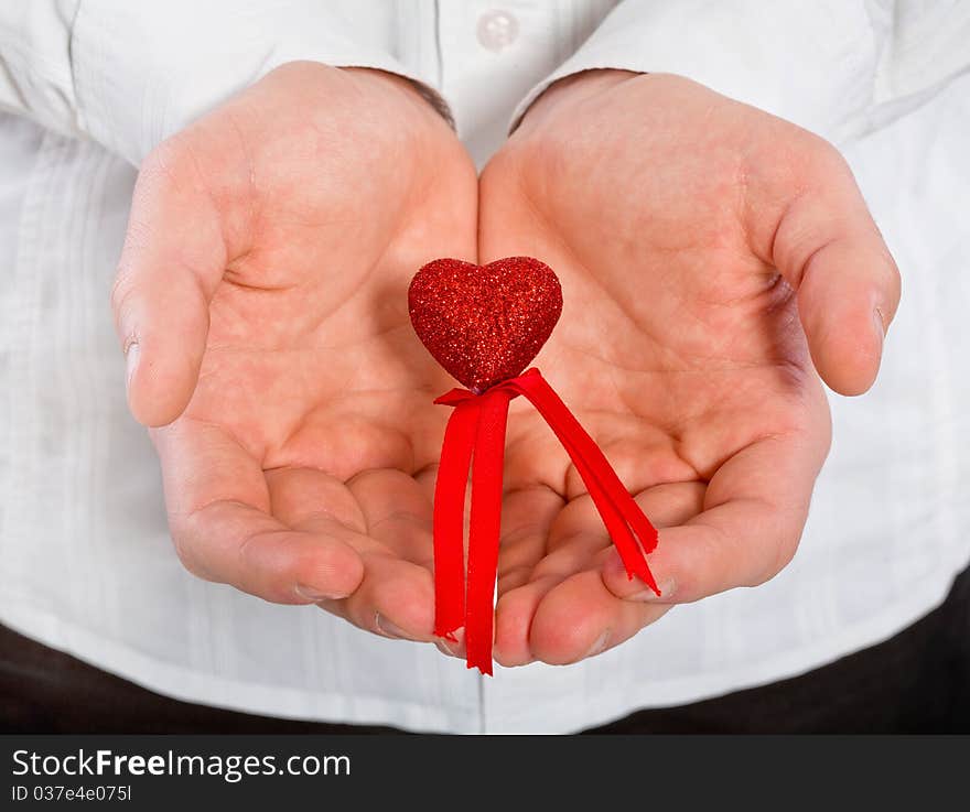 Red heart in man's hands