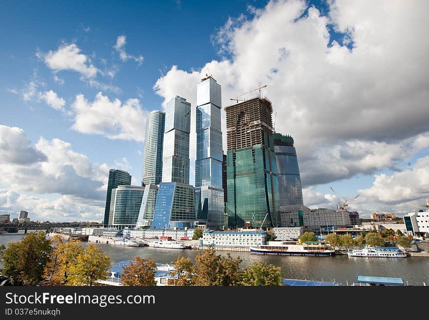 Many scyscrapers of Moscow city under blue sky with clouds