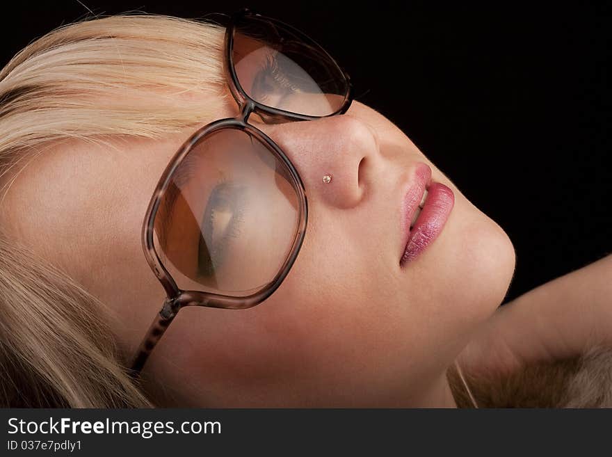 Girl in glasses posing to the camera