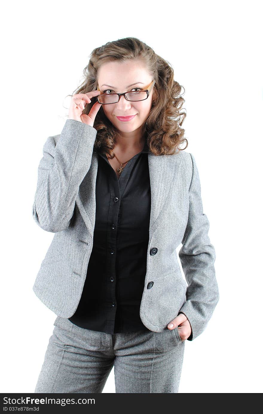 Beautiful young woman posing in business suit and glasses. Isolated over white background.