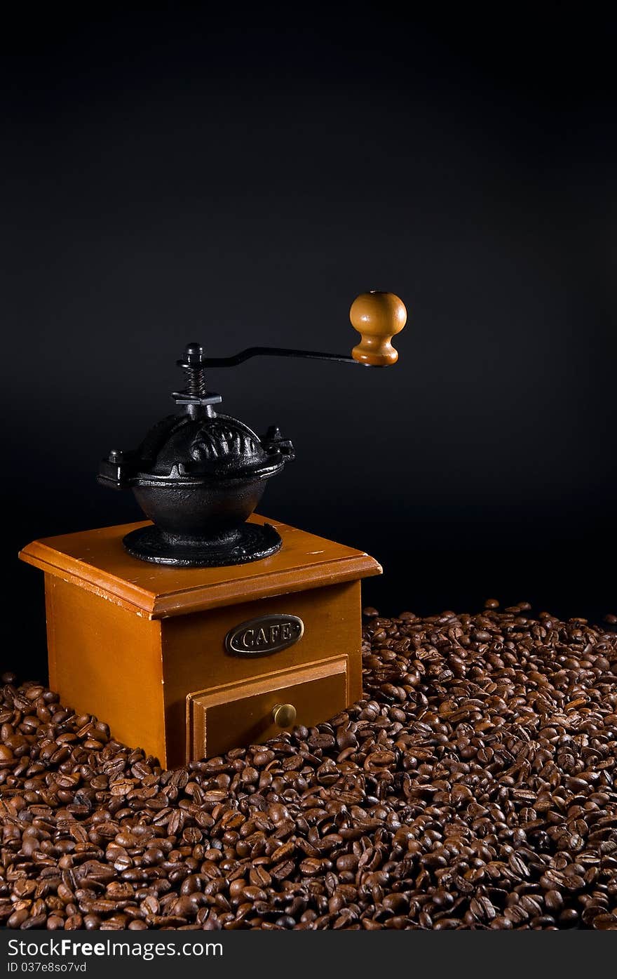 Coffebeans and grinder on a black background