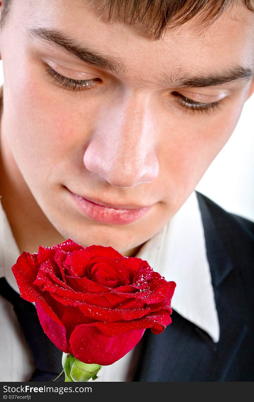 Man smelling a rose. Isolated