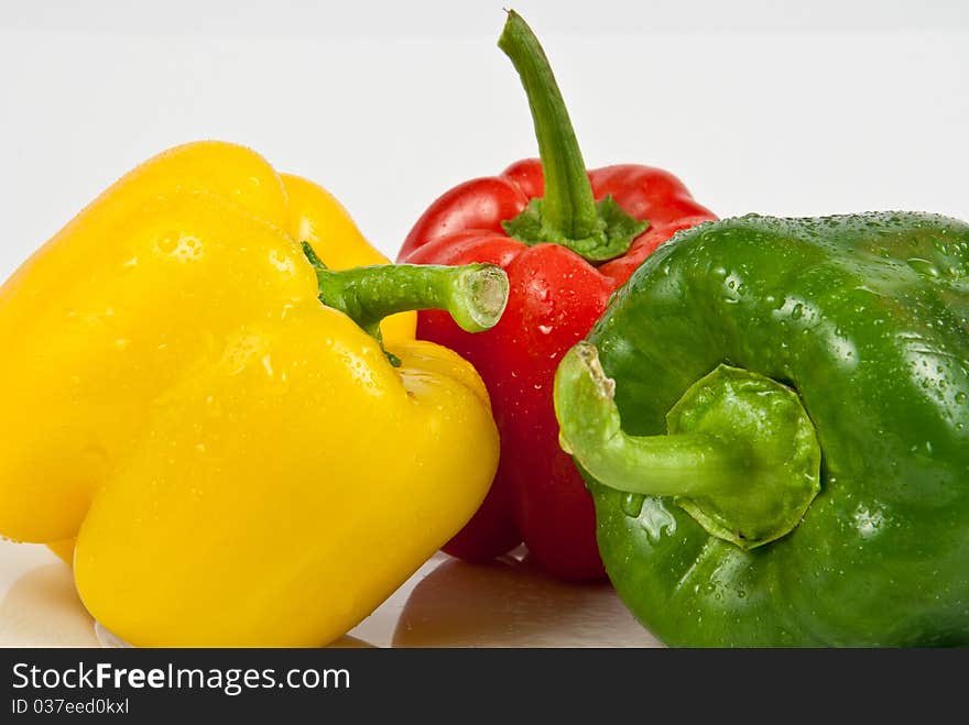 Wet bell peppers on a white background