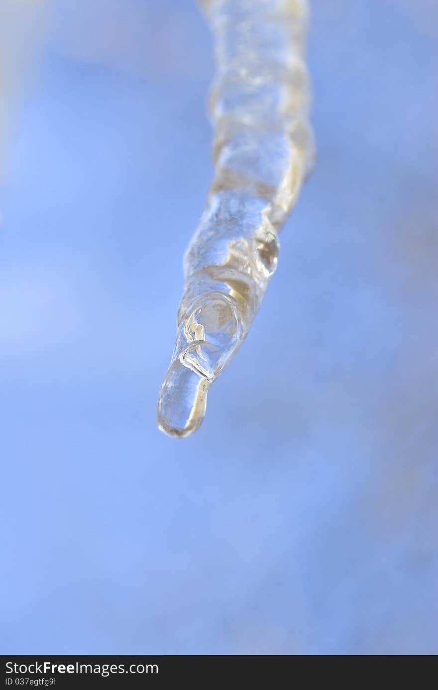 One icicle melting against the blue sky. One icicle melting against the blue sky.