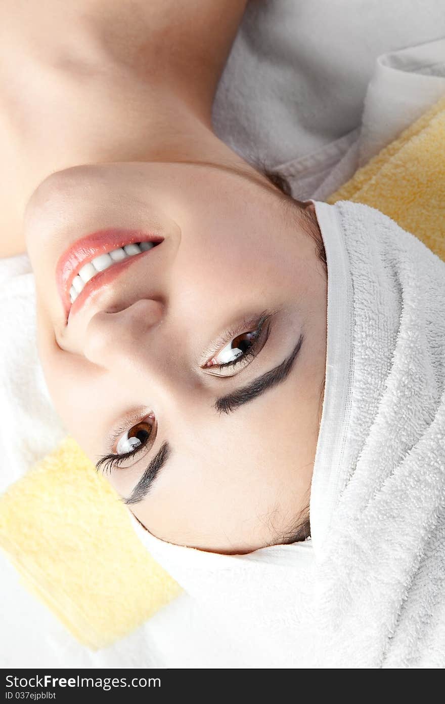 Woman in spa with Towel on hair over white background