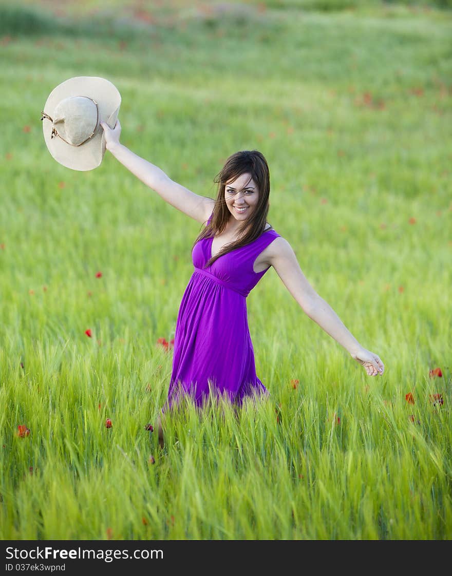 Young beautiful girl feeling freedom on meadow. Young beautiful girl feeling freedom on meadow