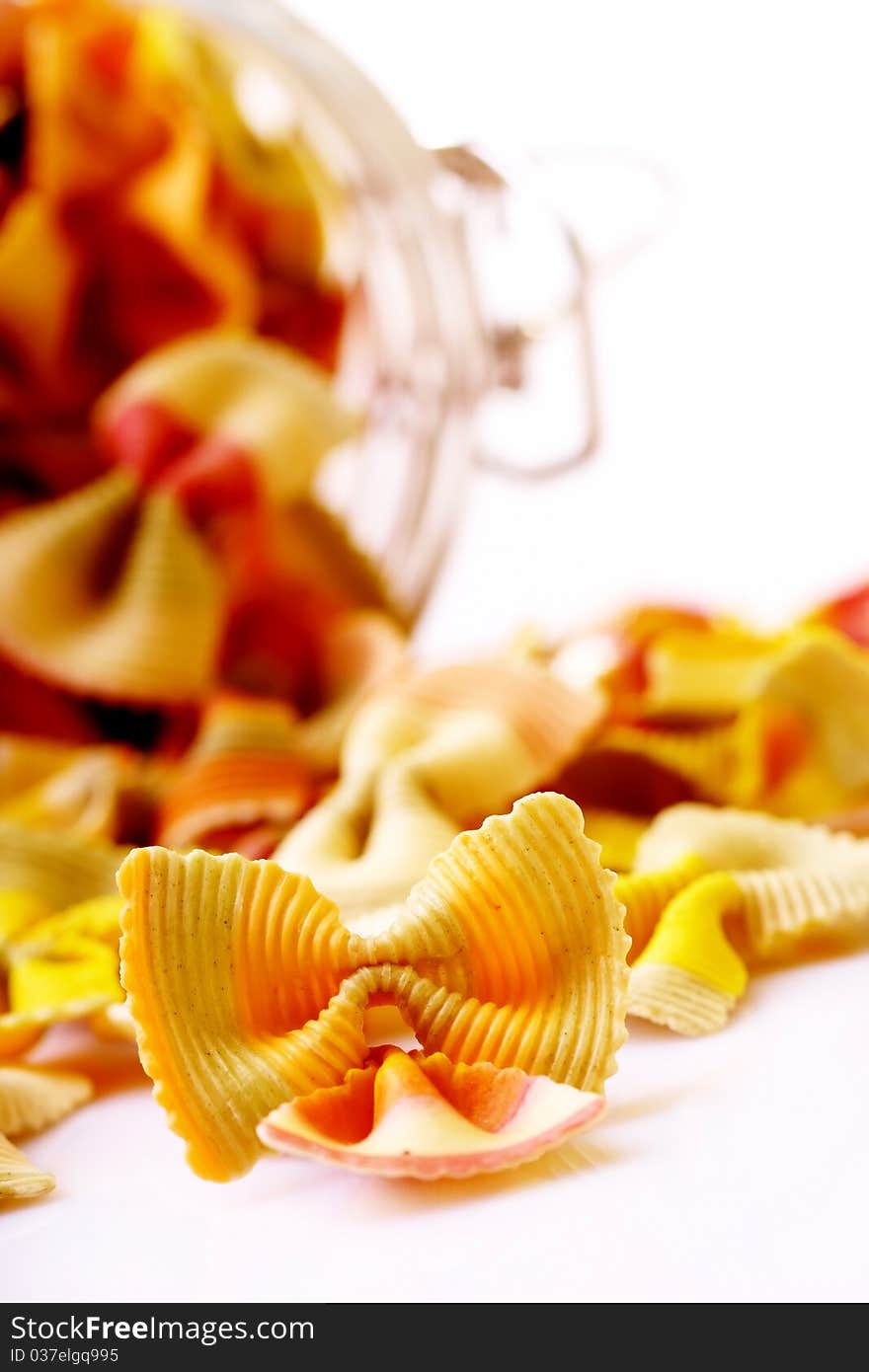 Farfalle pasta in a jar on white