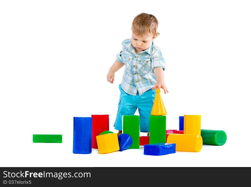 Cute little baby boy with colorful building blocks isolated on white