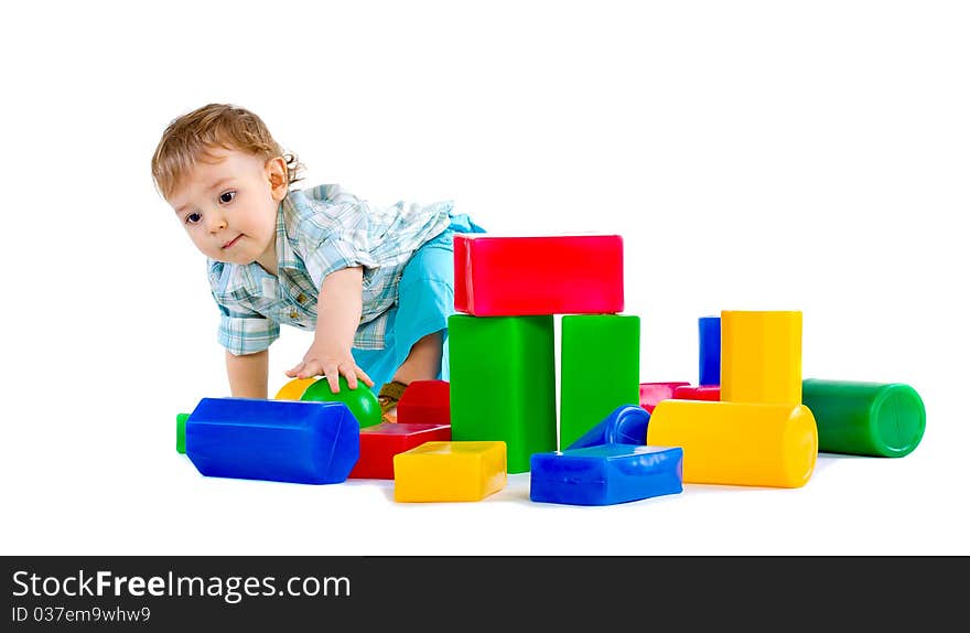 Cute little baby boy with colorful building blocks isolated on white