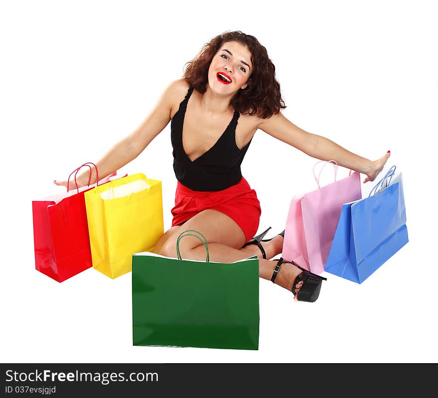 Happy shopaholic girl with colorful shopping bags