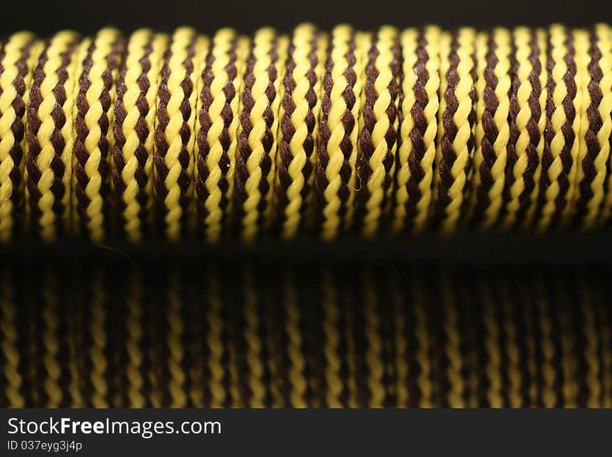 Closeup of a shoelace wrapped around a stick.