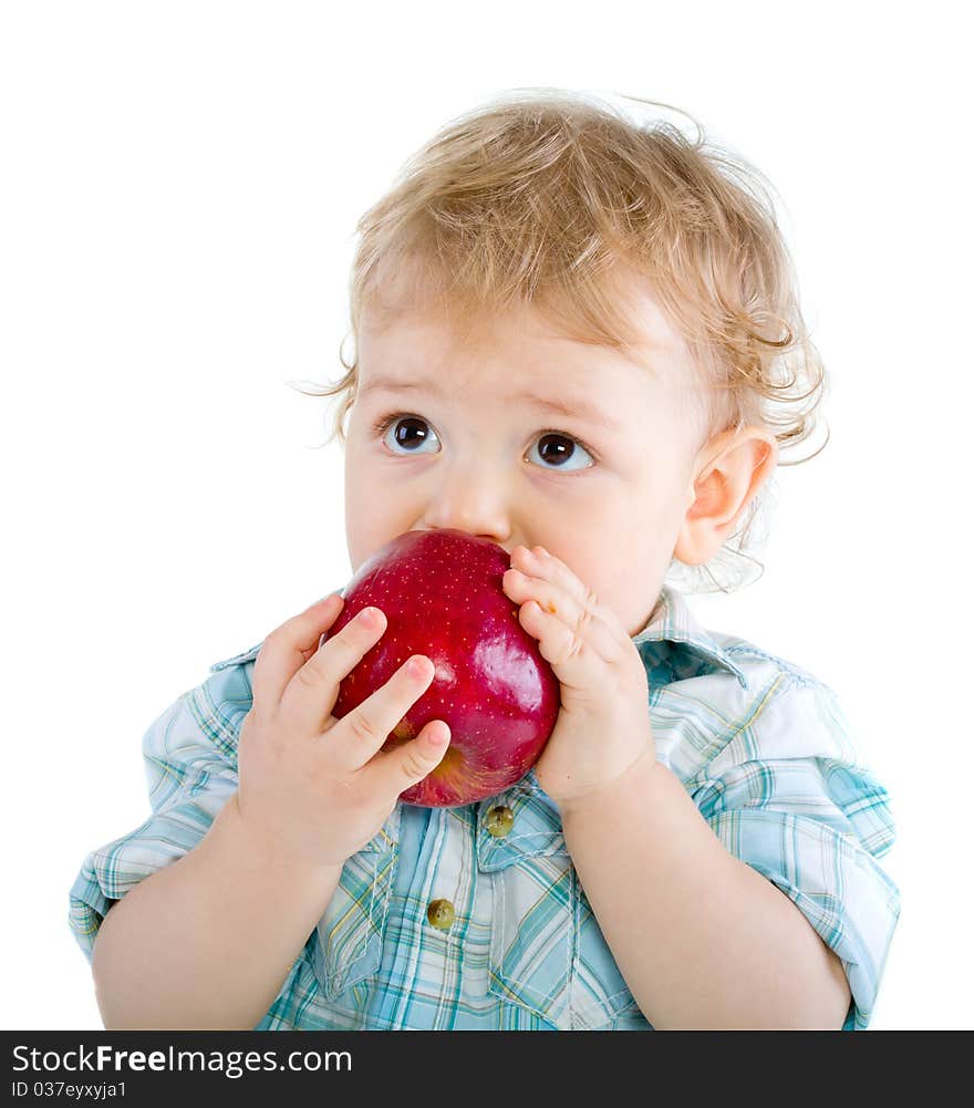 Beautiful baby boy eats red apple. Closeup portrait. Isolated.