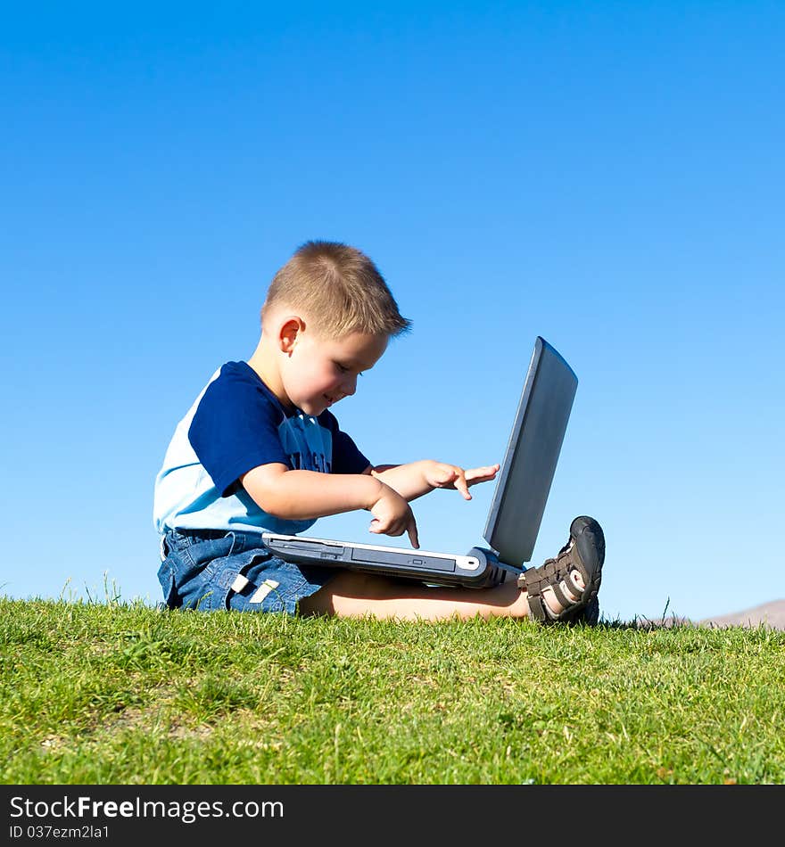 Little boy playing with laptop. Little boy playing with laptop