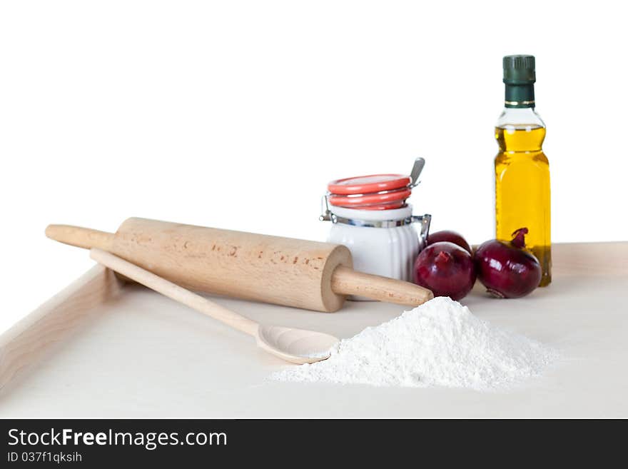 Pizza (bread) dough, olive oil, rolling pin with herbs and vegetables. Pizza (bread) dough, olive oil, rolling pin with herbs and vegetables