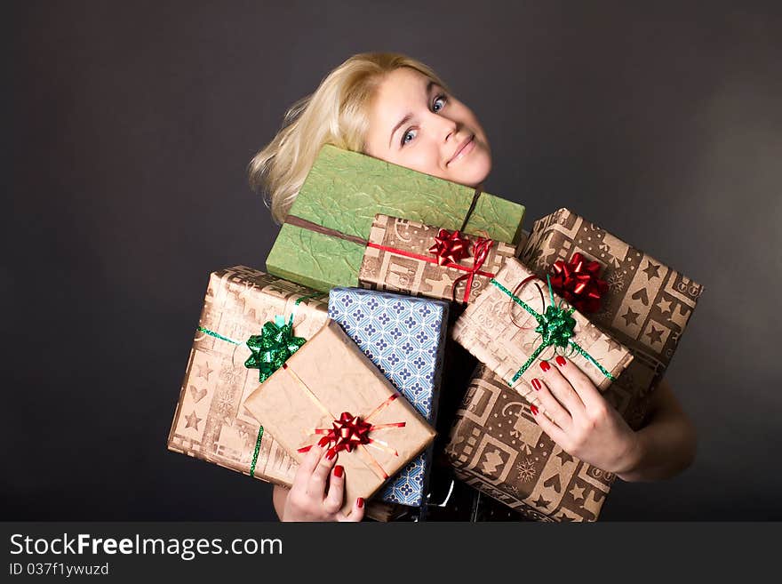 A Lovely Woman Holding A Many Gift Boxes