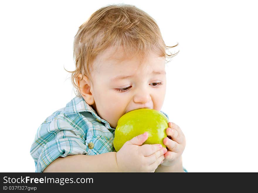 Beautiful baby boy eats green apple. Closeup portrait. Isolated.