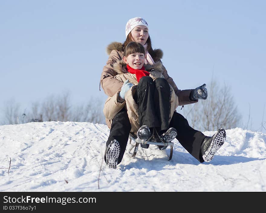 Two Happy Sisters Sledding