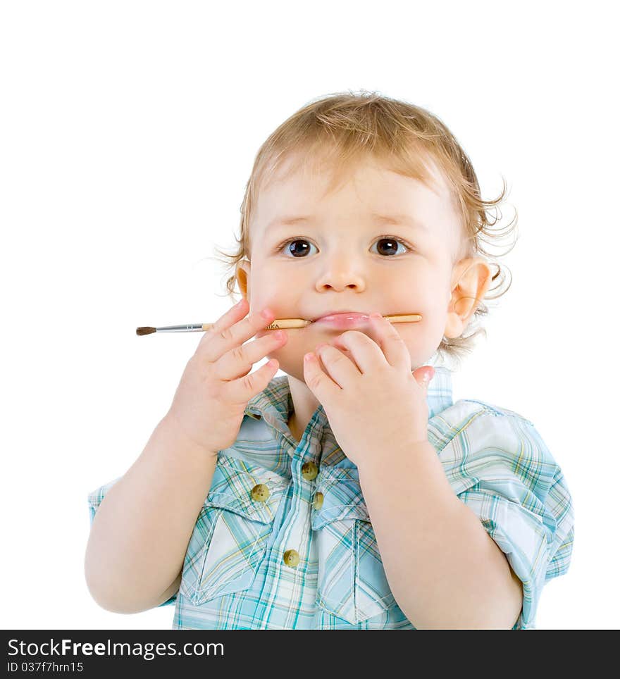 Beautiful baby with paint brush. Isolated.