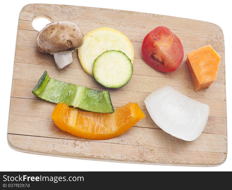 Variety of Vegetables Mushroom, Pepper, Onion, Tomato, and Sweet Potato on a Wooden Chopping Block.