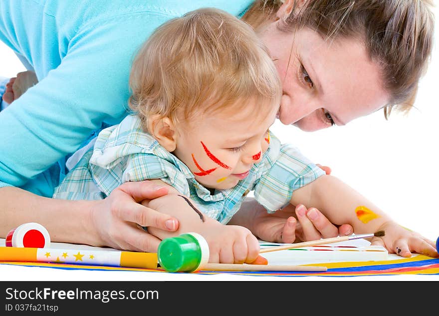 Young mum draws with the son paints. Isolated.