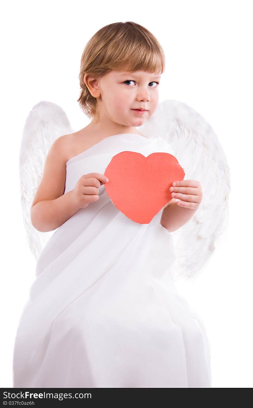 Boy angel with wings shows heart cut out of paper. Boy angel with wings shows heart cut out of paper