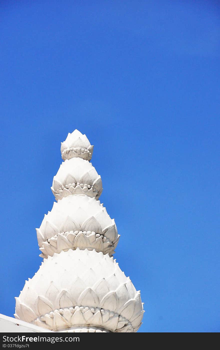 White lotus sculpture with blue sky